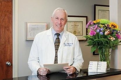 Professional Photograph of James D Wethe, MD in white labcoat in his office